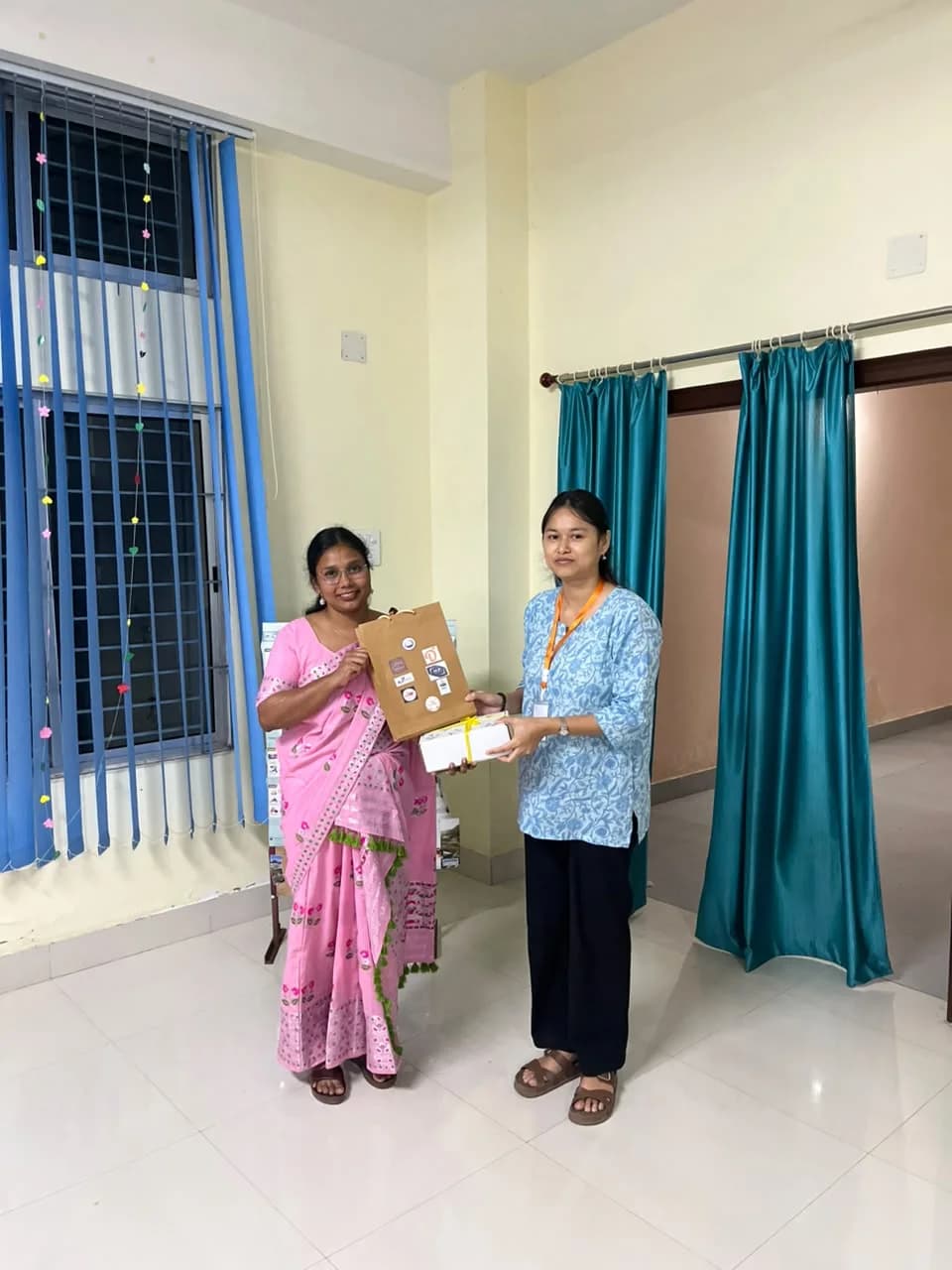 A member receiving a gift bag and box