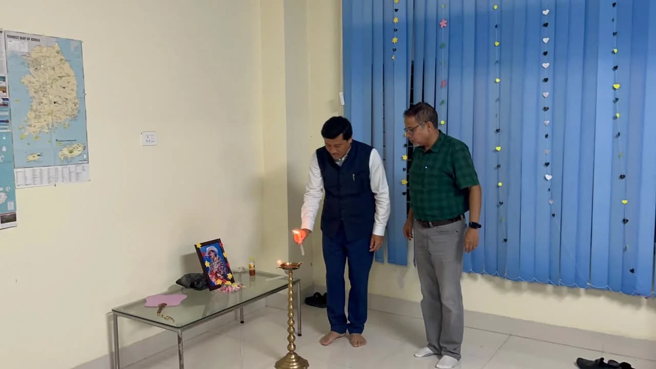 A guest lighting the ceremonial lamp to open the celebration