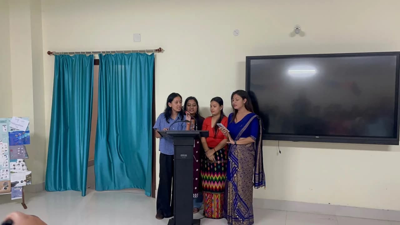 Four members singing at the podium
