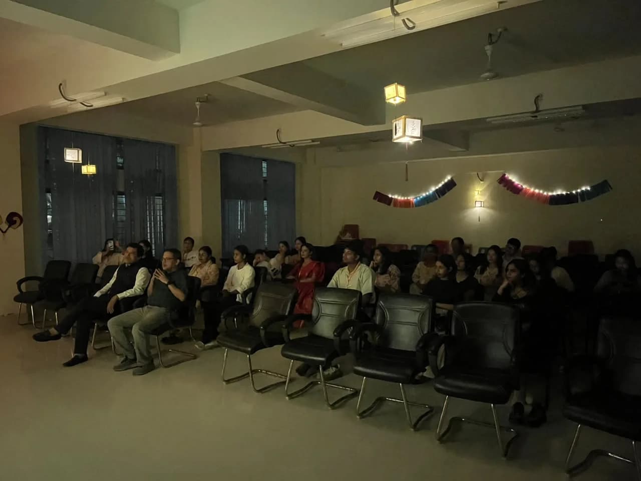 The audience watching the movie screening