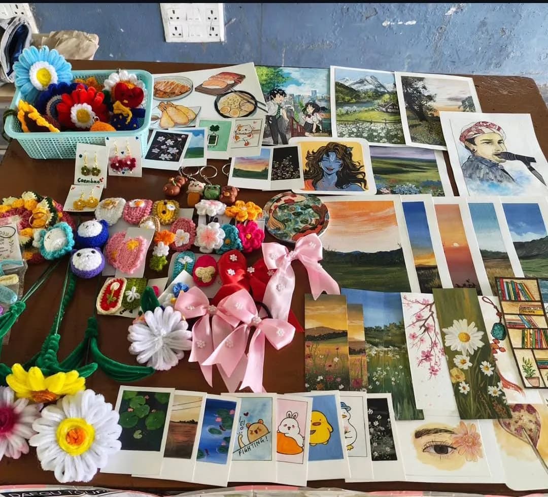 A table of crochet, hair bows, paintings and prints