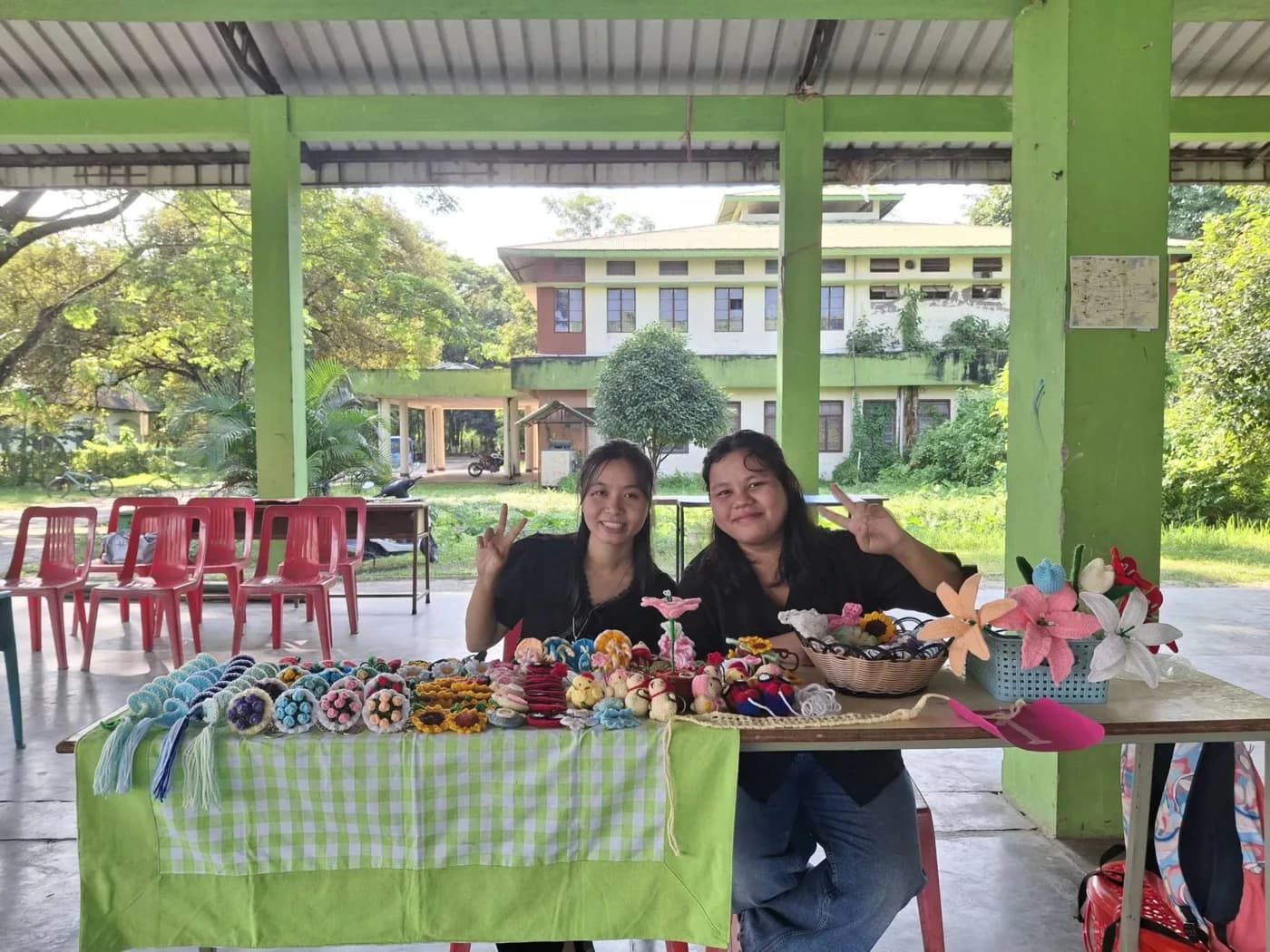 Two students with crochet flowers and keychains